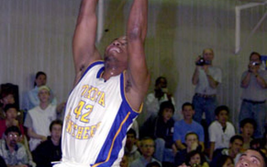 Yokota’s Mark Dixon puts up a lay-up as Seoul American defender Christopher Baker tries to chase him down during the Far East Boys Class AA finals on Kadena Air Base, Okinawa, Saturday.