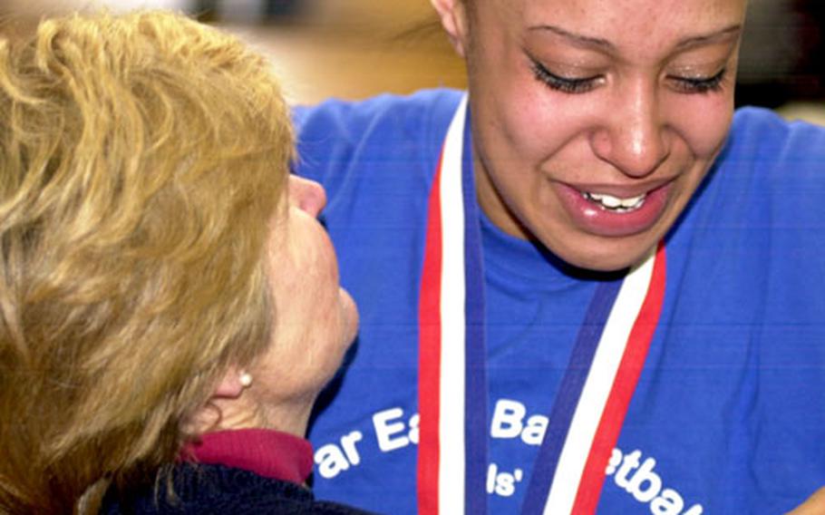 Seoul American senior center Margaret Nurse embraces coach Charlotte Hicks after Saturday’s Far East Class AA championship game at Yongsan Garrison, South Korea.