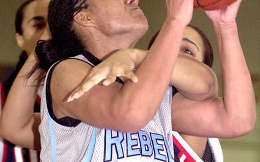 Ebony Irving of the Yongsan Runnin’ Rebels is fouled by Charlene Alexander of the Osan Defenders during Sunday’s women’s championship game in the 2006 Koreawide post-level basketball tournament on Yongsan Garrison, South Korea. Yongsan edged Osan 65-63.