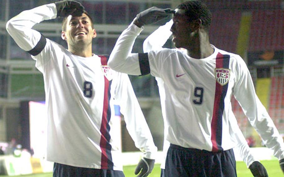 Clint Dempsey, left, and teammate Eddie Johnson of the U.S. celebrate Dempsey&#39;s game-winning goal against Poland with salutes.