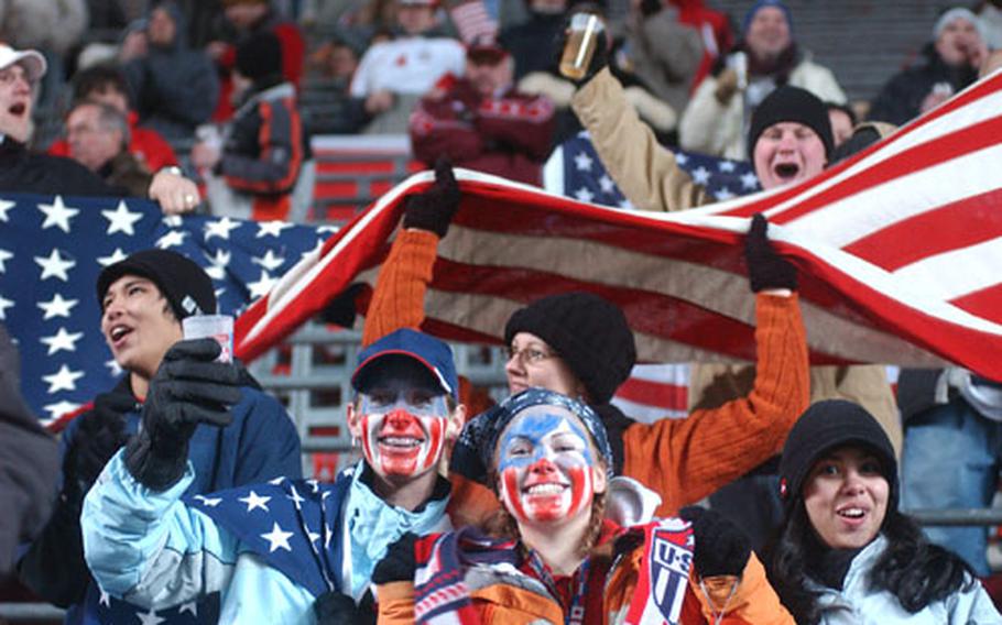 American fans cheer as the U.S. squad takes the field for the second half of their World Cup warmup friendly against Poland in Kaiserslautern, Germany, Wednesday night. 13,395 spectators, many of them Americans servicemembers stationed in Germany, braved freezing temperatures and second-half snow to see the U.S. beat Poland 1-0 on a Clint Dempsey goal.