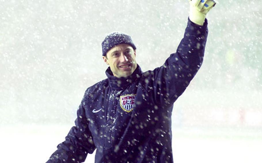 Through the snow, U.S. goalie Kasey Keller gives a thumbs-up to American fans after the game.
