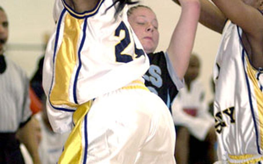 Yongsan Runnin’ Rebels guard Amanda Metzger is hemmed in by defenders Sharoeder Faulk, left, and Priscilla Bailey of the 2nd Infantry Division Warriors.