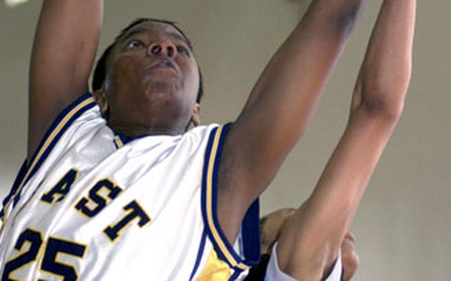 Shelly Jones (25) of the 2nd Infantry Division Warriors vies for a rebound with Ruthshell Bryant of the Yongsan Runnin‘ Rebels.