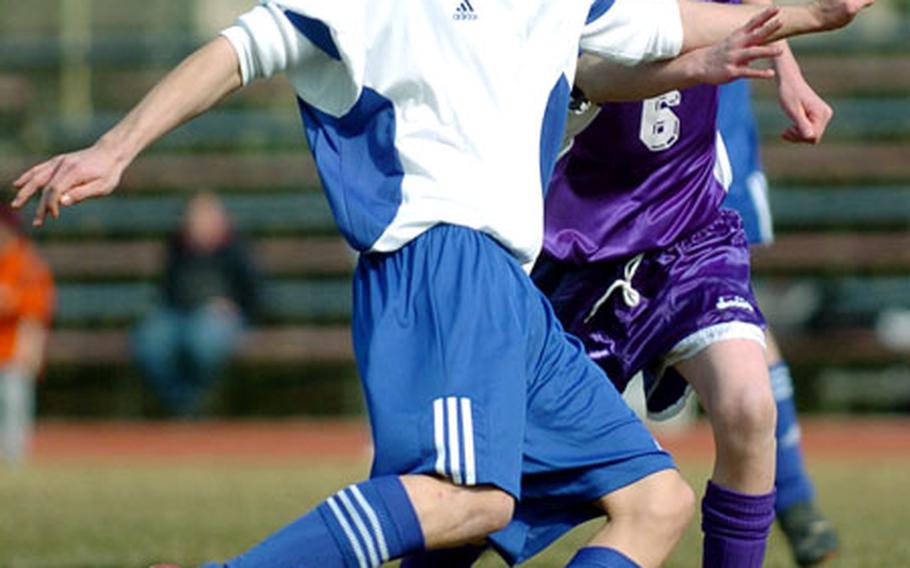 Ramstein&#39;s Jordan Borino takes a shot as Würzburg&#39;s Jacob Lamourex gives chase during opening day action of the DODDS-Europe soccer season, Saturday in Ramstein, Germany. Ramstein defeated Würzburg 7-0.