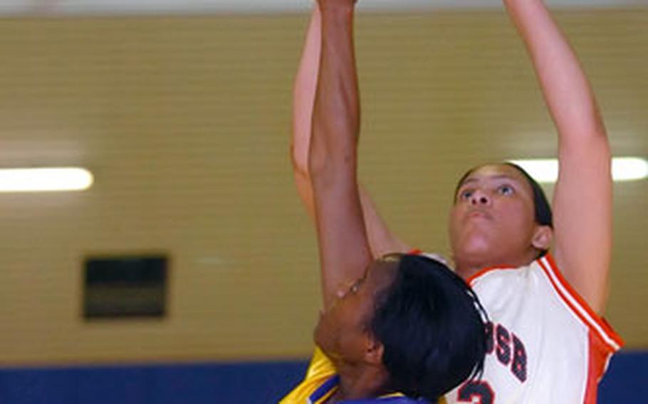 Kitzingen’s Bertha Kabuye puts up a shot over Wiesbaden’s Lamanda Morant during the finals of the Army Europe Community Level basketball championships in Hanau, Germany, on Sunday.