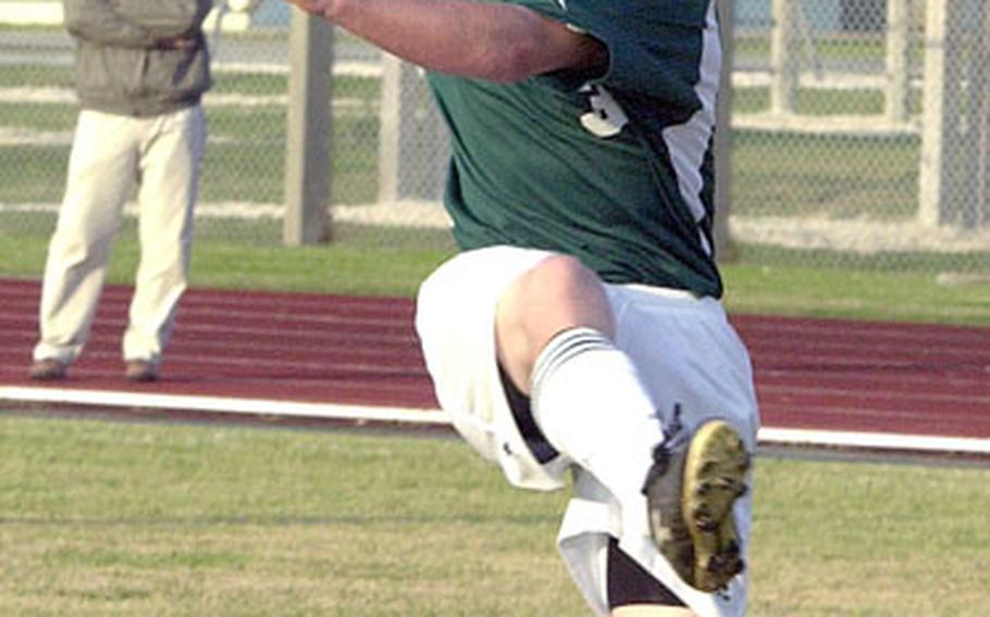 Freshman Jacob Hess of the Kubasaki Dragons boots the ball into Chatan High School territory during Wednesday&#39;s game at Camp Foster, Okinawa. The Dragons won, 4-1.