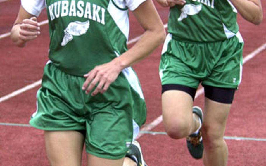 Lisa Nielsen of the Kubasaki Dragons and her senior twin sister Beth set the pace during the 3,200-meter race in Thursday&#39;s meet at Camp Foster. Beth rallied to win the race in 12 minutes, 18 seconds, and also won the 1,600 in 5:53, one second ahead of her sister each time.