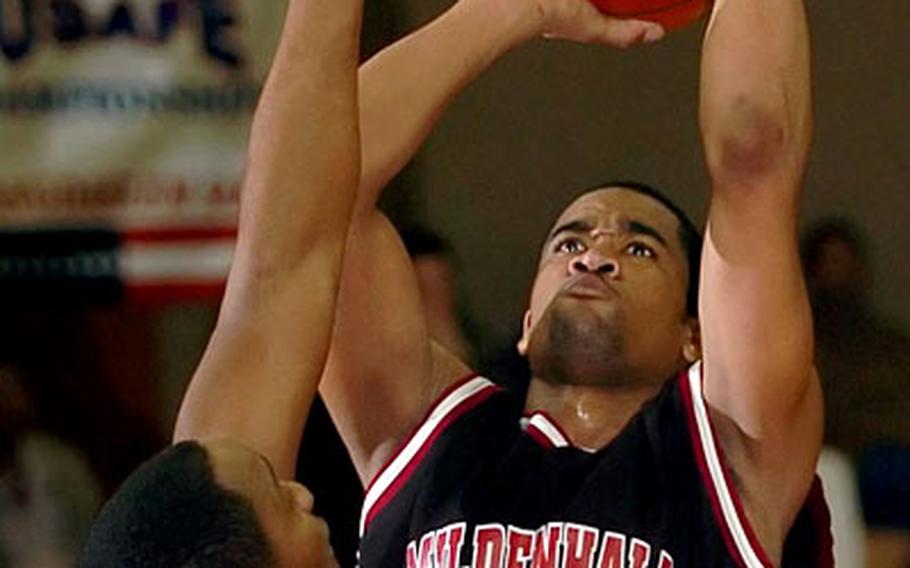 Mildenhall’s Dylan Goldwire scores over Ramstein’s Larry Senegal.