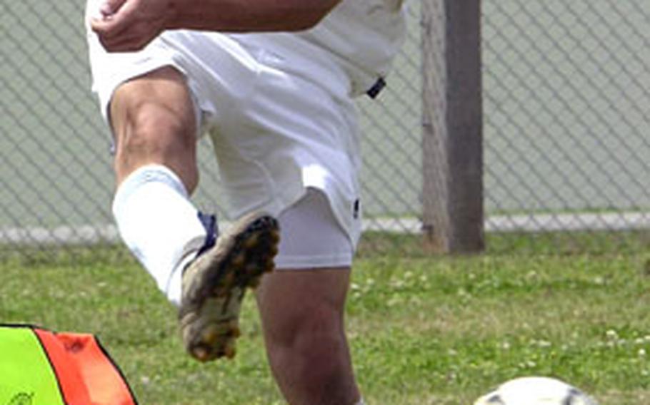 Michael Derr of the Kubasaki Dragons kicks the ball out of the Shuri High School zone during Saturday’s boys soccer match at Camp Foster, Okinawa. Shuri edged Kubasaki 5-4.