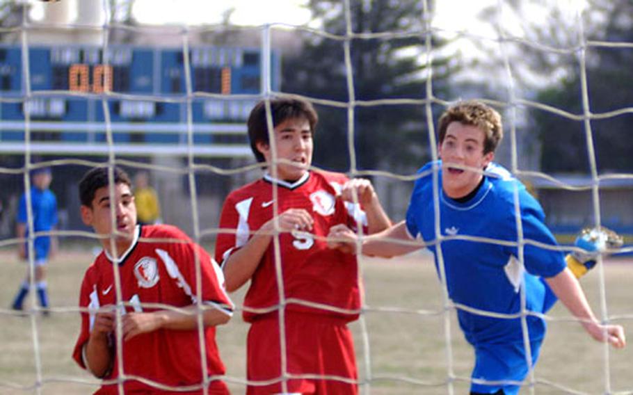 Scott Monahan, right, of the Yokota Panthers heads a corner kick past two Nile C. Kinnick Red Devils defenders into the net during Saturday’s JSL match at Yokota Air Base, Japan. Yokota won 3-1 in a battle of the past two JSL champions.