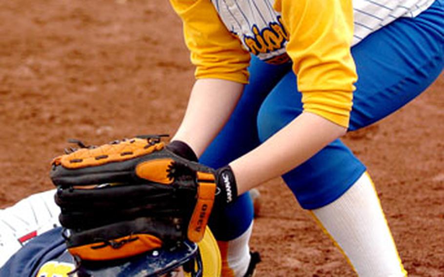 Heidelberg’s Brittany Bailey scrambles safely back to first as Wiesbaden’s Shannon McCoy applies the tag.