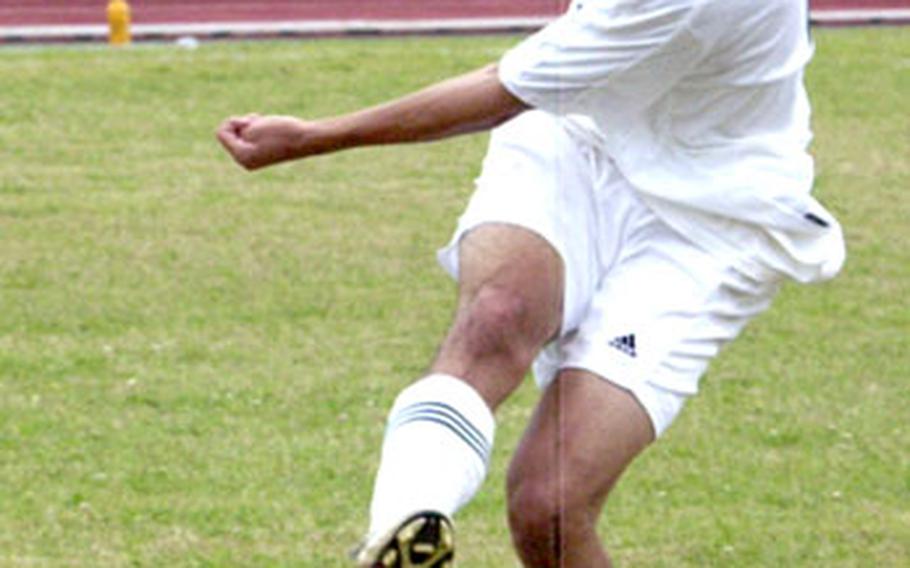 Kubasaki senior Eric Isley boots the ball during a boys soccer match Saturday on Camp Foster, Okinawa. Kubasaki beat Itoman 5-3.