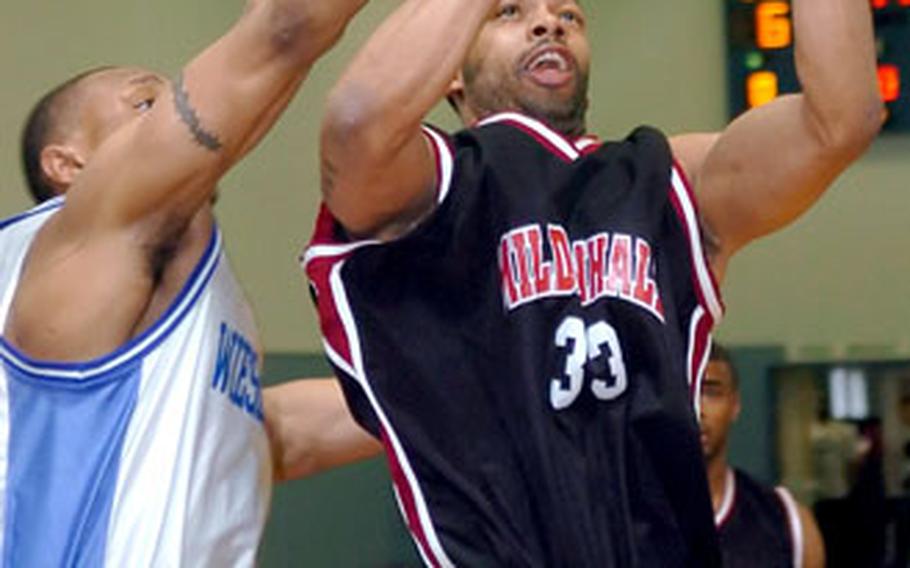 Wiesbaden’s Matthew Royal blocks the shot of Mildenhall’s Adam Hodges.