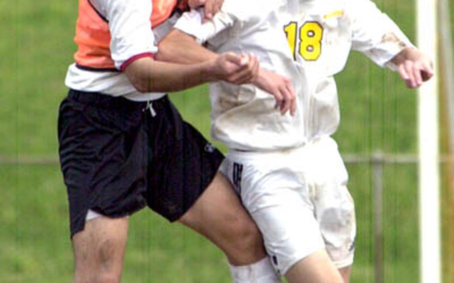Kadena Panthers senior Jose Muniz, right, battles a Kyuyo defender during Kadena’s 5-0 win on Wednesday.