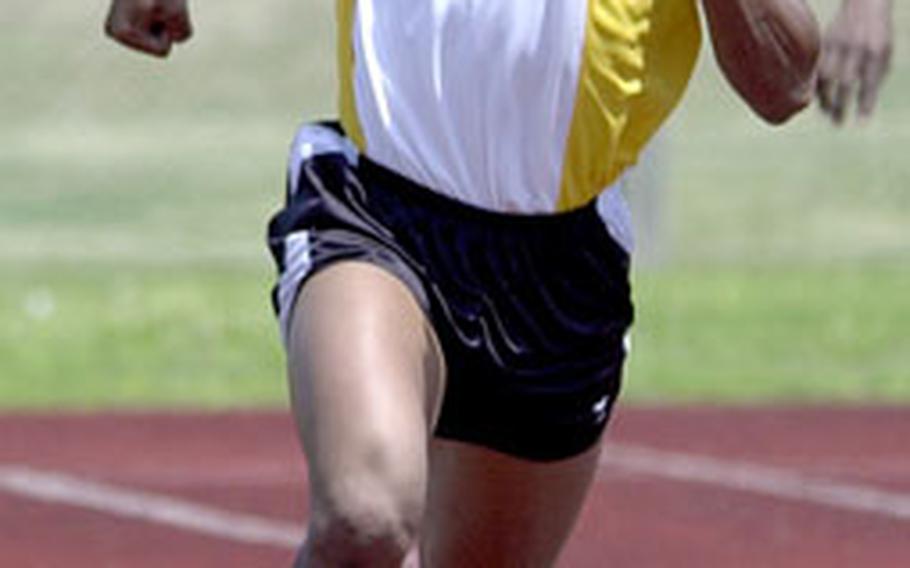 Kadena junior Manuel Duran speeds around the final turn for the finish line during Saturday’s boys 400 relay. Kadena won with a meet-record time of 45.84 seconds.