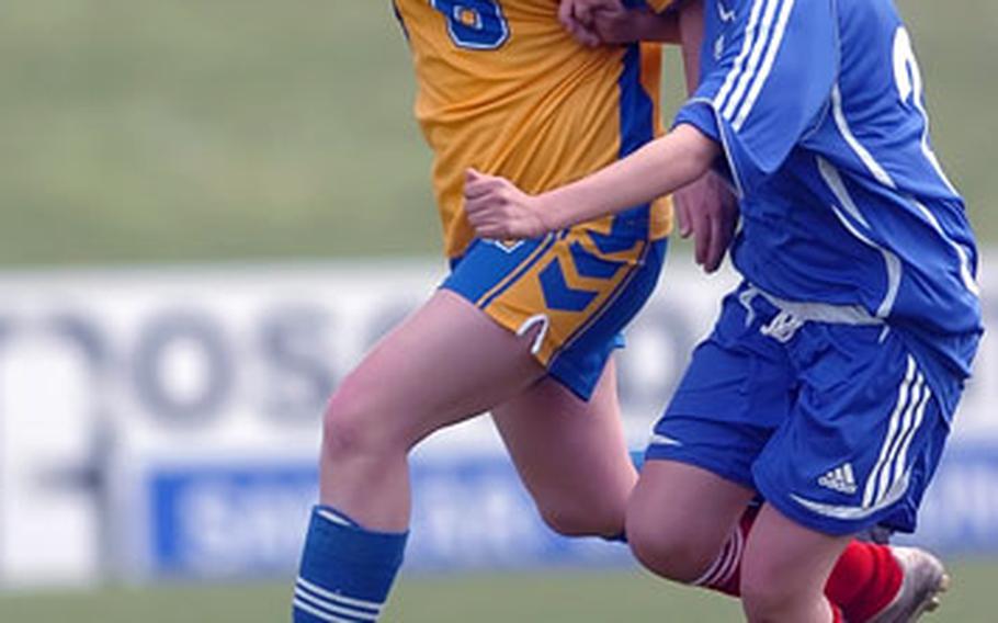 Ramstein’s Lauren Williams, right, dribbles past Wiesbaden’s Brittany Foster during a DODDS-Europe soccer match in Mainz, Germany, on Saturday. Williams scored on the play as Ramstein defeated Wiesbaden, 5-0.