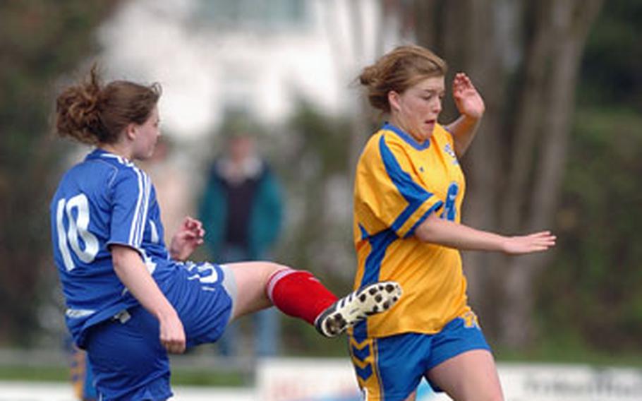 Ramstein’s Sarah Moore kicks the ball over Wiesbaden’s Brittany Foster during a DODDS-Europe soccer match in Mainz, Germany, on Saturday.