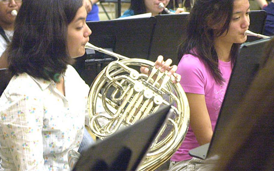 Beth and Lisa Nielsen are concentrating on another passion of theirs this week: playing the French horn at the Far East High School Music Festival on Camp Foster, Okinawa.