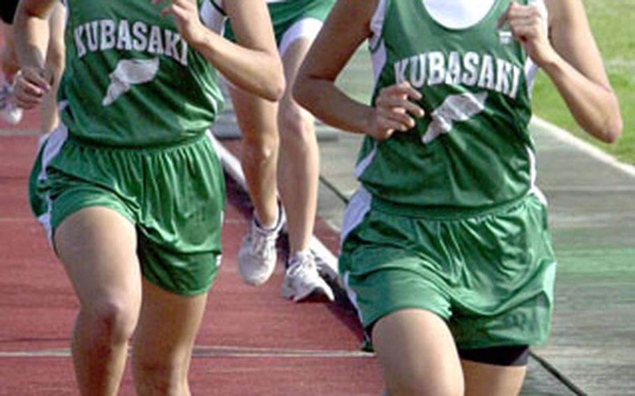 Kubasaki senior twins Beth and Lisa Nielsen lead the pack in the 3,200 on Friday. Beth Nielsen, right, won in 12 minutes, 37 seconds.