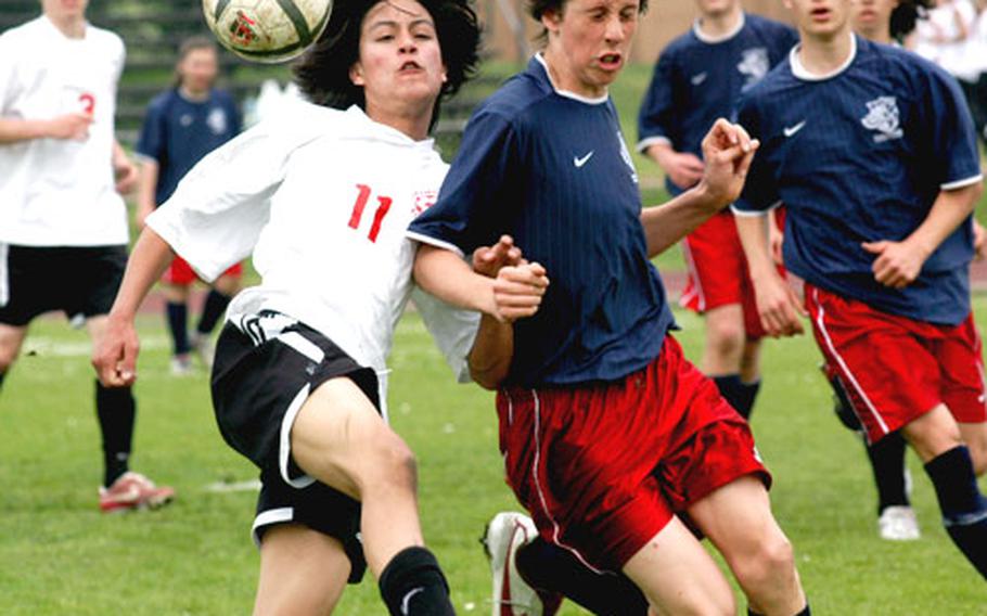 Lakenheath High School sophomore Chris Davis, left, and International School of Brussels sophomore Alex Haigh fight for a loose ball Saturday at the two schools&#39; final conference game at RAF Lakenheath. ISB, the regular-season champion, won 4-2.