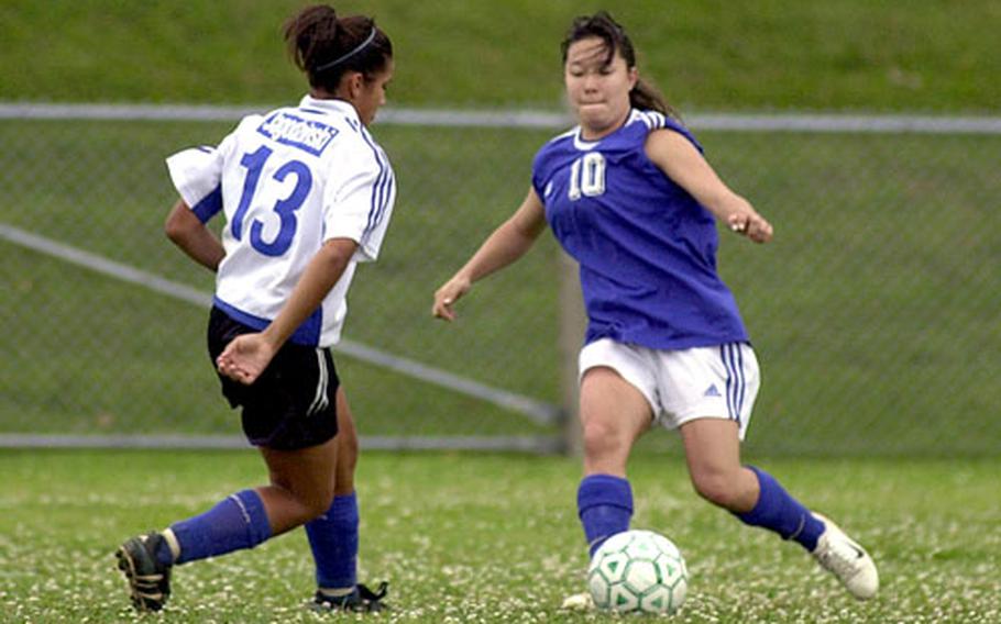 Seoul American’s Angie Vandersys, right, faces Guam High’s Sarah Jagodzinski during Far East Girls Class AA tournament action on Camp Foster Monday. Seoul American topped Guam 2-0.