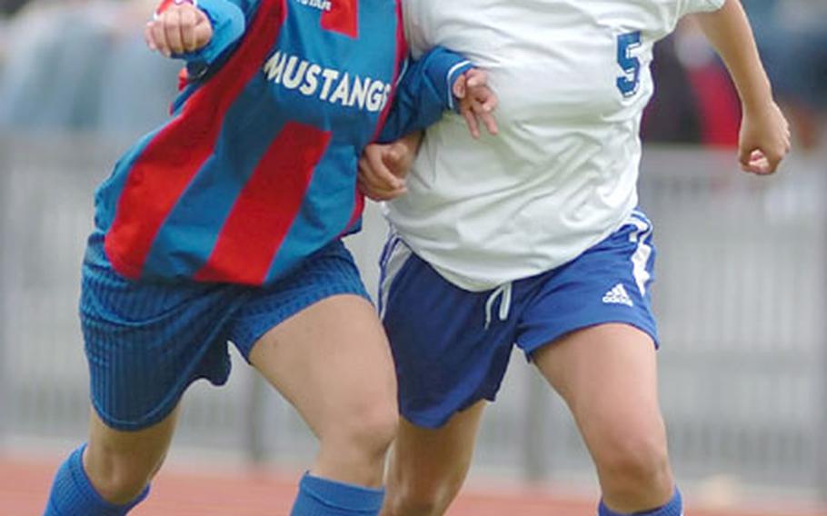 Menwith Hill&#39;s Jennifer Abing, left, and Brussels&#39; Brianna Fitch battle for the ball during the girls title game in the DODDS-Europe Division IV soccer tournament in Ramstein, Germany, on Friday. Brussels defeated Menwith Hill 5-1.