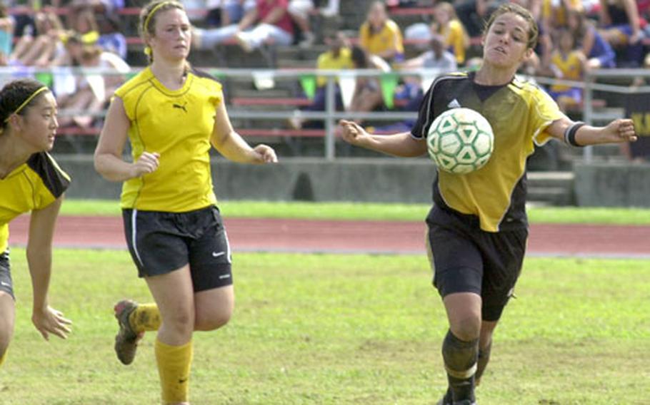 Kadena’s Dianne Abel knocks the ball down against American School in Japan during the championship game of the Far East Girls Class AA Soccer Tournament on Camp Foster, Okinawa, on Friday.