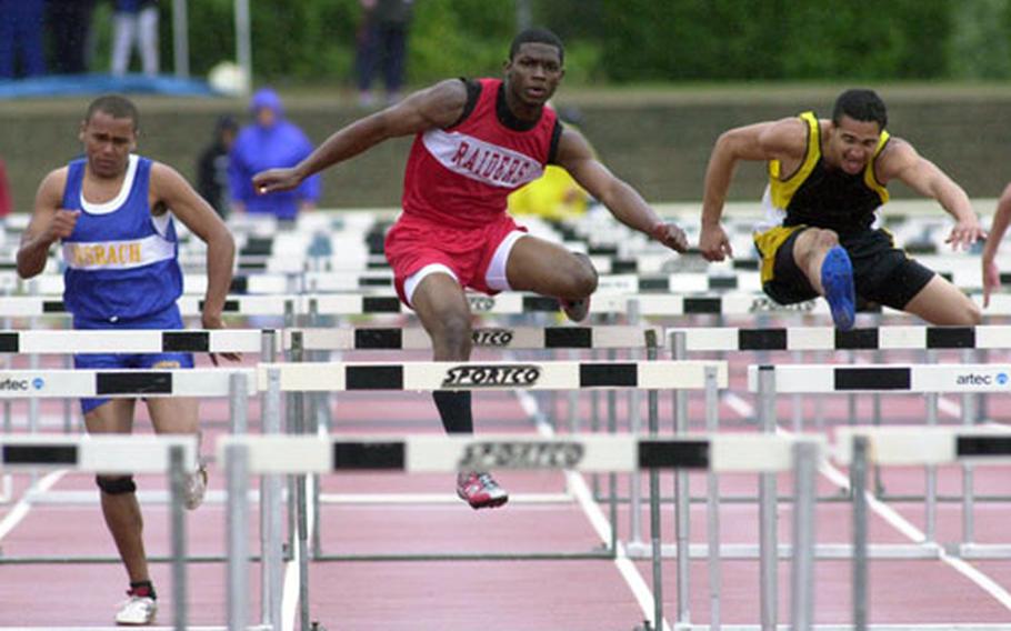 Kaiserslautern’s Quintin Strawder, center, clears a hurdle on his way to winning the 110-meter high hurdles in 16.26 seconds at the DODDS European track and field finals in Wiesbaden on Saturday. At left is Ansbach’s John Willis-Morris; at right is Hanau’s Aaron Ellison.