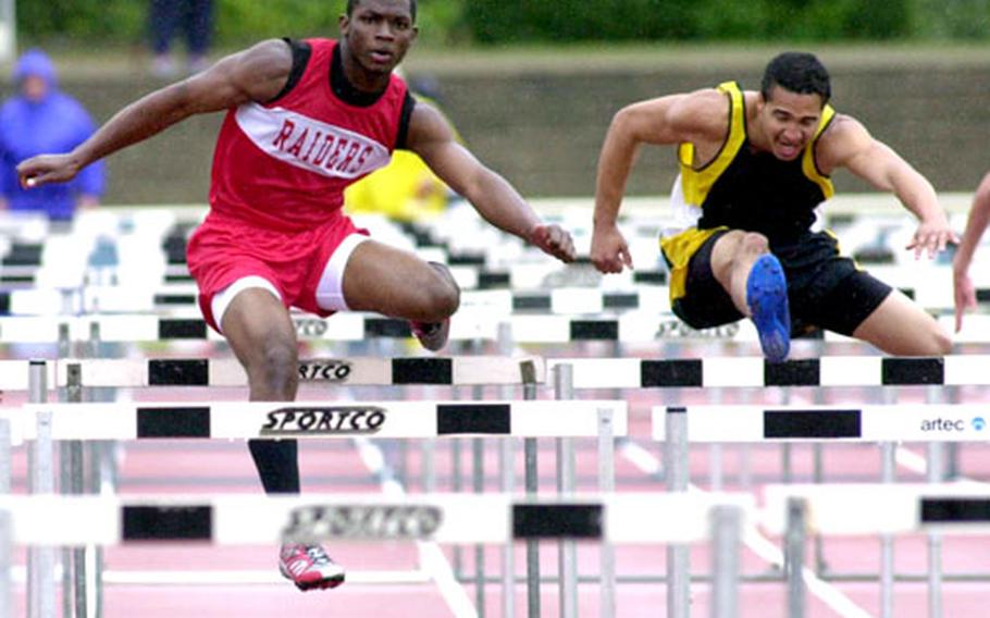 Kaiserslautern’s Quintin Strawder, left, clears a hurdle on his way to winning the 110-meter high hurdles in 16.26 seconds in the European track and field championships in Wiesbaden, Germany, on Saturday. At right is Hanau’s Aaron Ellison. Strawder’s surprise victory helped the K-town boys win the team title.