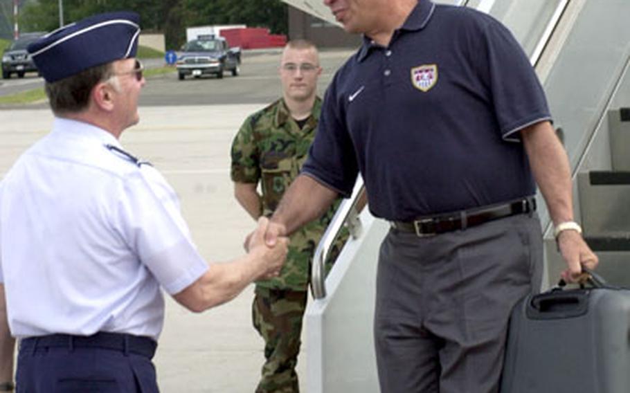 U.S. men’s soccer coach Bruce Arena, is greeted by Gen. Tom Hobbins, U.S. Air Forces in Europe commander, Thursday upon landing at Ramstein Air Base.