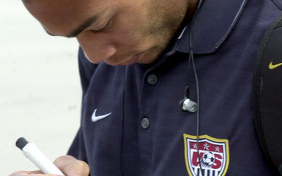 Oguchi Onyewu, a defender for the U.S. men&#39;s soccer team, signs an autograph Thursday evening at Ramstein.