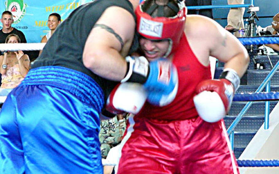 Open super heavyweight champion Isaac Mendoza of Giebelstadt, right, mixes it up with Wiesbaden’s Matthew Dusch on Sunday during the U.S. Forces Europe championship bout at Wiesbaden Army Airfield, Germany. Mendoza came back from a second-round knockdown to claim the title when Dusch didn’t answer the bell for the fourth and final round.