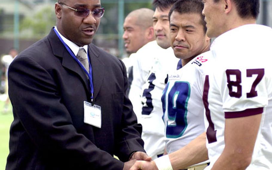 Joe Howell, left, a player and coach in the U.S. Forces Japan-American Football League who also served a term as league commissioner, is leaving Yokota to transfer Altus Air Force Base, Okla.