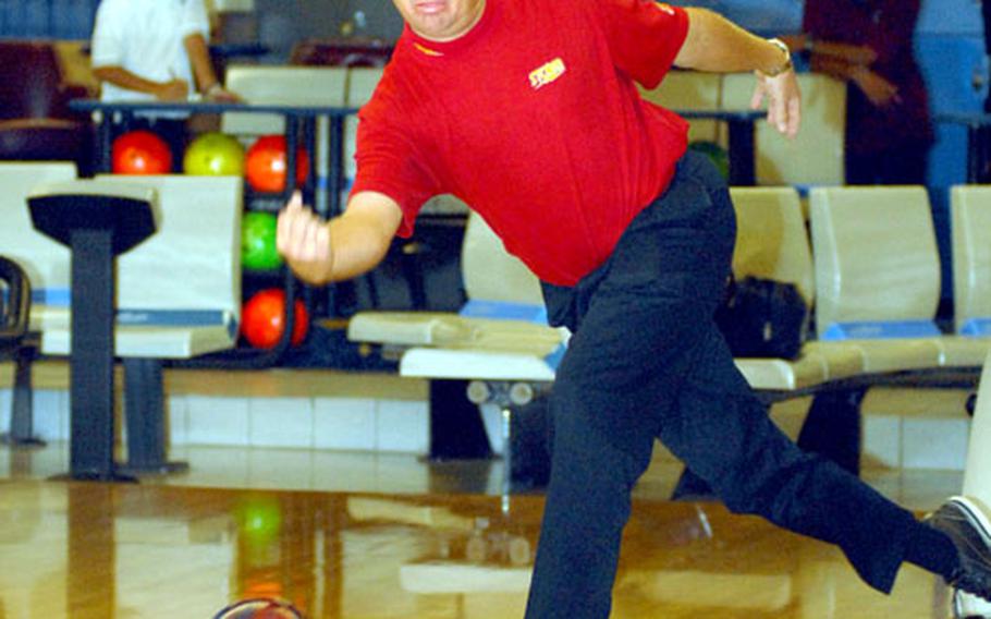 Professional bowler Randy Pedersen demonstrates his release during a clinic he and fellow PBA pro Robert Smith gave for adults on Friday at Emery Lanes, Kadena Air Base, Okinawa. Smith and Pedersen also participated in a pro-am tournament with Kadena personnel on Saturday and were to conduct a Sunday clinic for children at Emery.