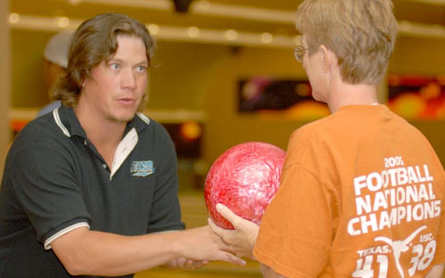 Professional bowler Robert Smith gives some advice to Rhonda Fay during the clinic on Friday at Emery Lanes.