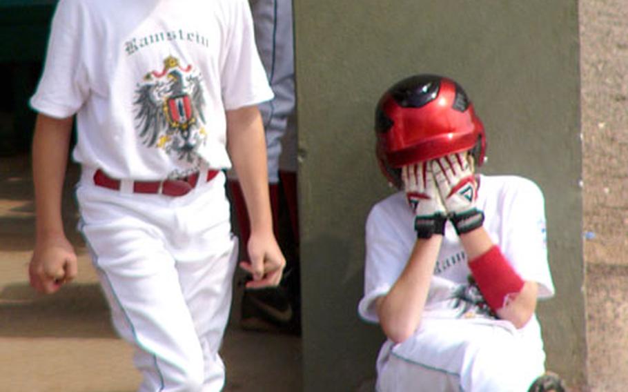 Cody Warner hides his eyes as teammate David Novak watches Ramstein&#39;s last-inning rally attempt on Tuesday. Ramstein erased most of a 10-0 deficit to Dubai in Little League Baseball&#39;s Transatlantic Regional tournament but fell out of the event after a 10-8 loss.