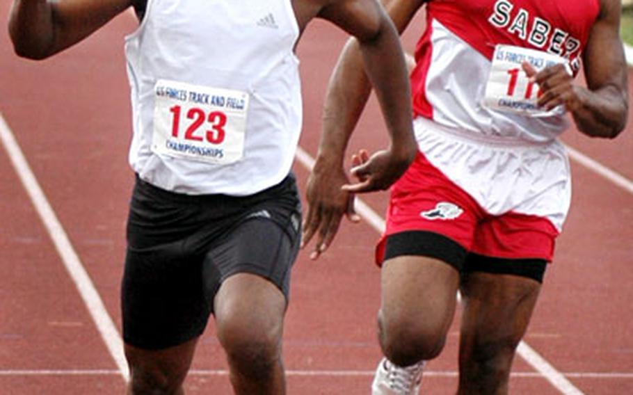 Jamie Eckford, left, of Bamberg edges out Douglass Schmidt of Spangdahlem to win the men's 100-meter dash at Saturday's U.S. Forces Europe Track Championship at Baumholder, Germany.