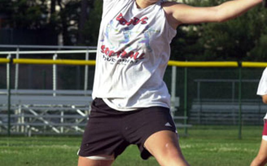 Kristan Burns, 14, a member of the Kaiserslautern, Germany, Junior fastpitch softball team, delivers a pitch during practice at Ramstein Air Base last week.