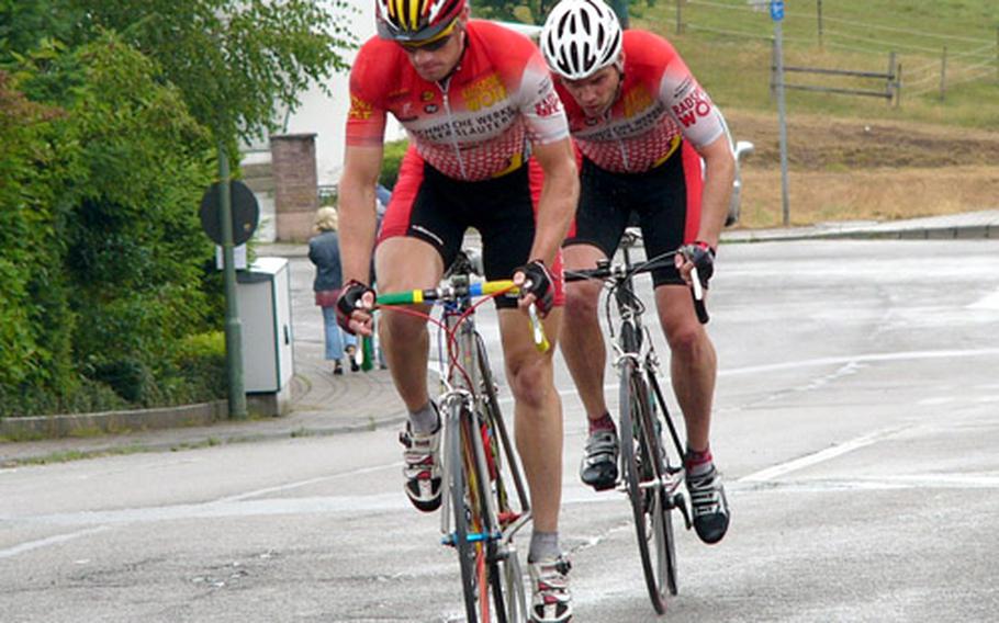 Thomas Essick of Wiesbaden pulls his longtime training partner and German cycling club teammate Trent Hornus of Ramstein through a rainy, uphill stretch of the U.S. Forces Europe road cycling series race. Hornus edged Essick, both 30-39-year-old seniors riders, at the finish line of the 40-kilometer event.