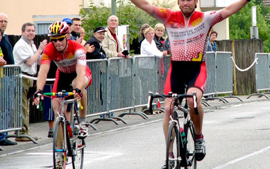 Men&#39;s senior winner Trent Hornus of Ramstein greets the completion of Saturday&#39;s race. Hornus, a longtime military cycling champion, edged teammate Thomas Essick of Wiesbaden, left, in the 70-kilometer event.