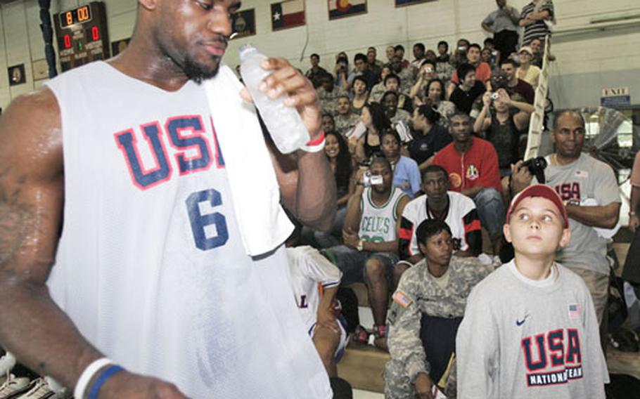 LeBron James chats with fan Zach Buhrer, 10, on Monday after practice at Yongsan Garrison.