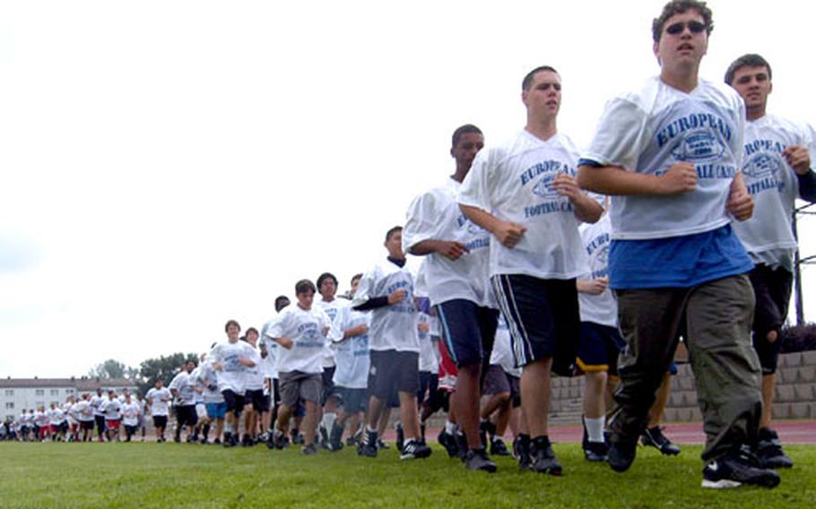 The 495 prospective football players from 24 DOODS-Europe schools take their warmup laps for the second session of the 2006 DODDS European Football Camp.
