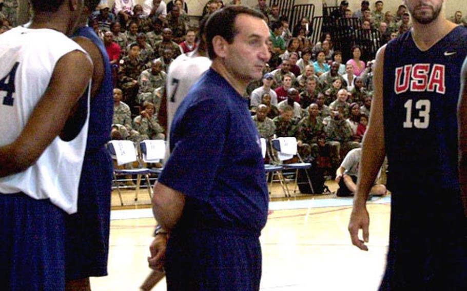 Team USA and Duke University basketball coach Mike Krzyzewski watches his players get ready for a scrimmage before about 1,000 servicemembers at Camp Casey’s Carey Gym on Wednesday.