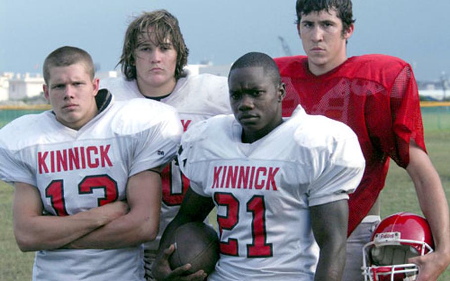 Nile C. Kinnick Red Devils senior fullback Andrew Preston (13), sophomore lineman Chad Atchley, senior running back Larynzo Abernathy (21) and senior quarterback-receiver Clay Atchley pause during Monday’s practice at Yokosuka Naval Base, Japan.