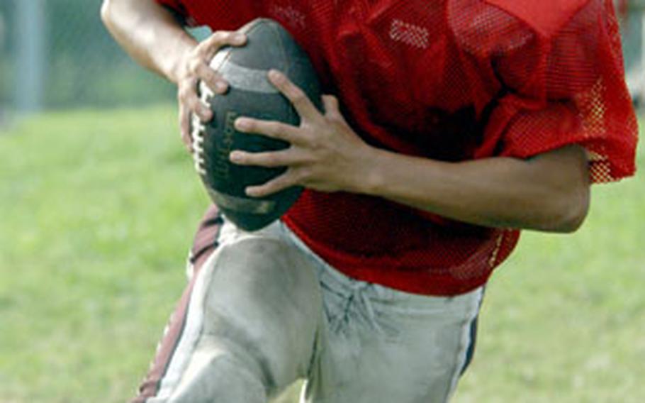 Nile C. Kinnick quarterback Jeff Galang runs the option during Monday’s practice at Briggs Bay athletic complex, Yokosuka Naval Base, Japan.