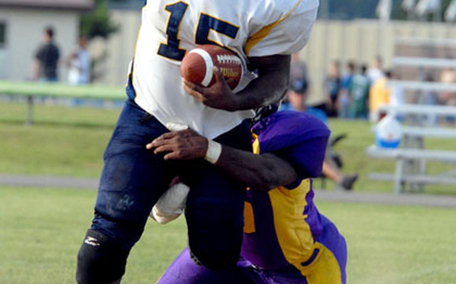 Yokota Warriors running back Kevin Hill tries to evade the grasp of Misawa Marauders defender Direck Sorrell during Saturday’s USFJ-AFL semifinal at Misawa Air Base, Japan. Defending champion Misawa shut out Yokota 13-0 to reach its third straight USFJ-AFL Torii Bowl championship game.