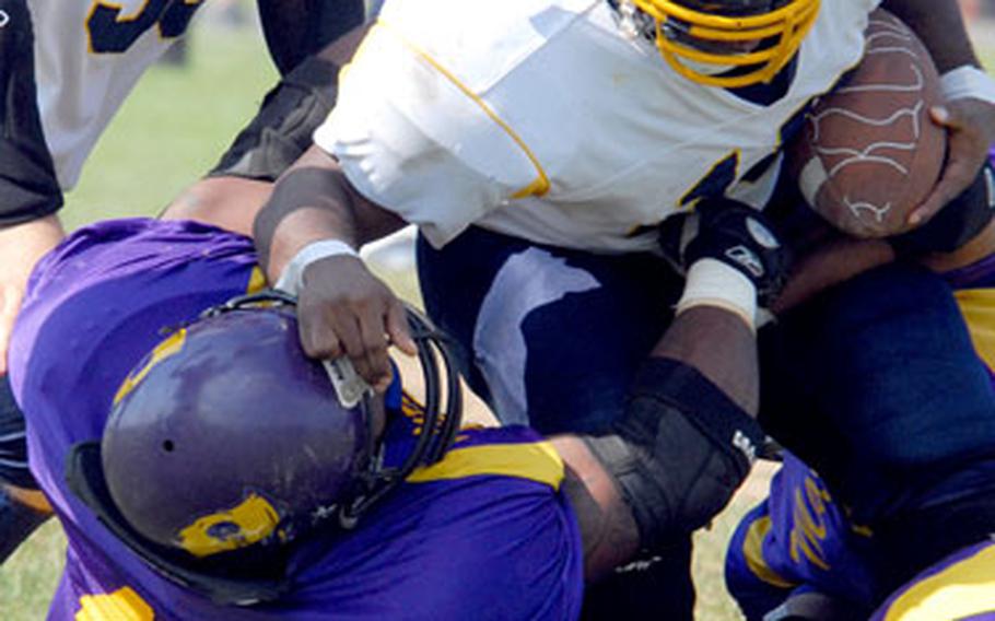 Yokota Warriors running back Kevin Hill gets tackled by Misawa Marauders defender Andre Gaskin (43) during Saturday’s USFJ-AFL semifinal at Misawa Air Base, Japan.