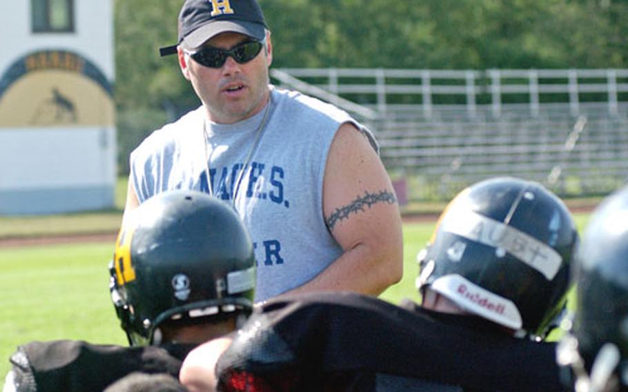 Hanau High School football coach Sam Cassou talks to his team during practice. Defending DODDS-Europe Division II champ Hanau is competing in Division III this year, due to a drop in the size of the school&#39;s student body.