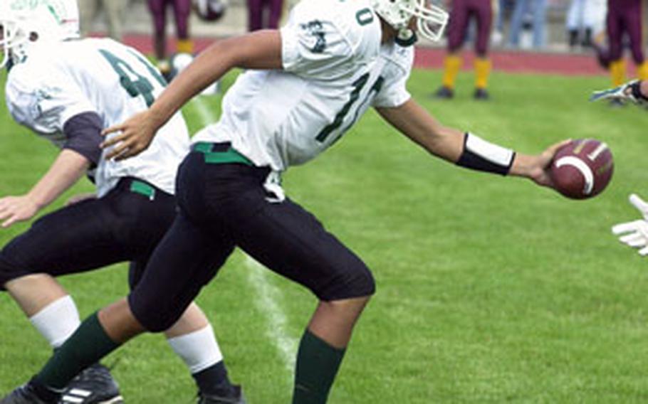 Naples QB Tyler Terronaz hands the ball off during Saturday’s 54-40 victory over Vilseck.